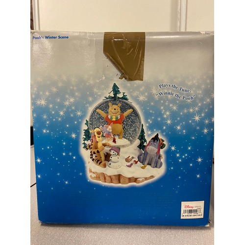 79 - Large Disney Store Poohs winter scene musical snow globe with box. 8.5