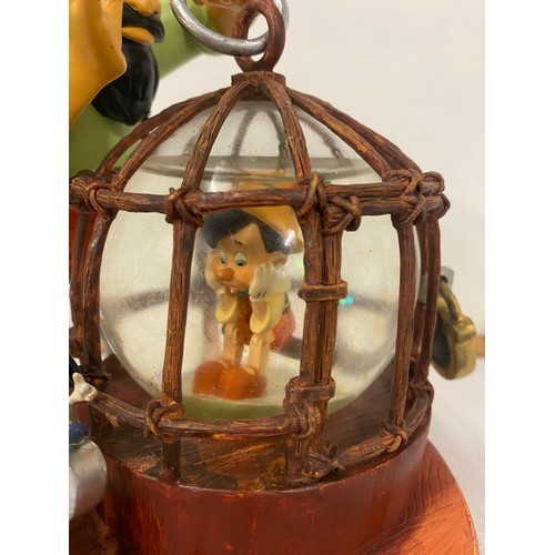 95 - Large Disney store Pinocchio & Stromboli snow globe. 8.5