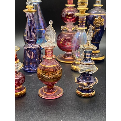 203 - Collection of 11 Egyptian hand blown glass scent bottles. tallest 7