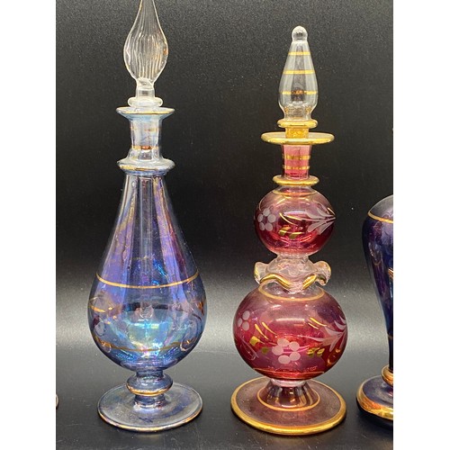 203 - Collection of 11 Egyptian hand blown glass scent bottles. tallest 7