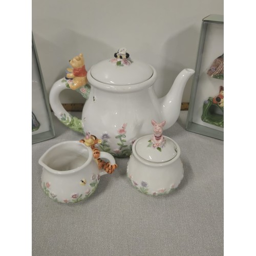 121 - Vintage Disney Simply Pooh teapot, sugar & creamer along with Disney Winnie the Pooh napkin rings.