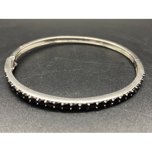 146 - Cif Jacobs sterling silver, 23 blacl cz stones hinged bangle. Fully hallmarked SJJ.