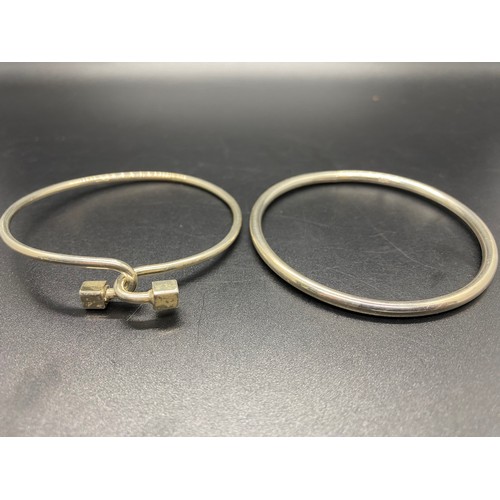 147 - 2 x silver 925 bangles to include classic smooth bangle and interlocking cube end.