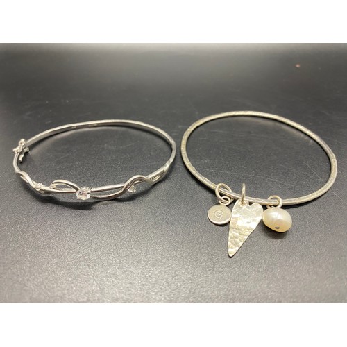 149 - 2  x silver 925 bangles to include classic round clasp and triple charm.