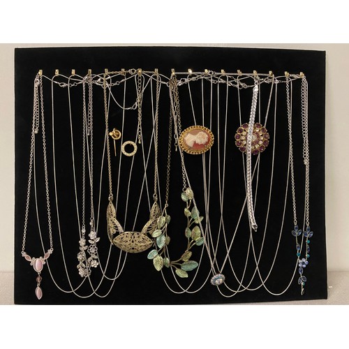 186 - Large collection of assorted jewellery to include brooches, chains and necklaces on velvet display b... 