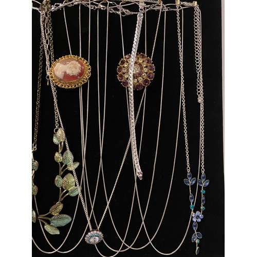 186 - Large collection of assorted jewellery to include brooches, chains and necklaces on velvet display b... 