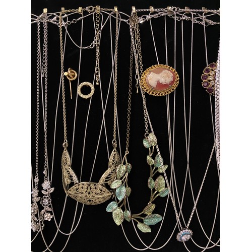 186 - Large collection of assorted jewellery to include brooches, chains and necklaces on velvet display b... 