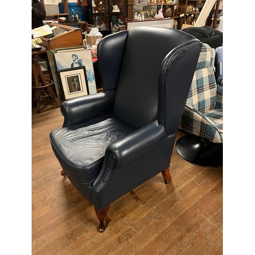 238 - Blue leather wingback arm chair.