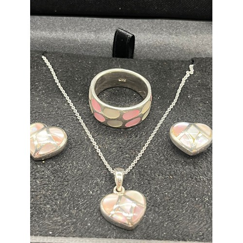 62 - Silver and mother of pearl heart shaped jewellery set to include pendant, chain, earrings and ring.