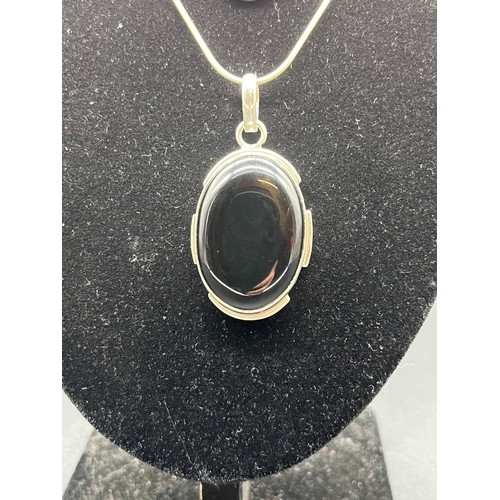 66 - 2 silver 925 oval pendants and chains to include amethyst and Whitby jet colour stones.