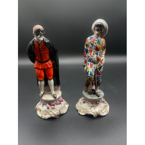 90 - A pair of antique chelsea pottery figures to include masked harlequin & masked figure with black coa... 