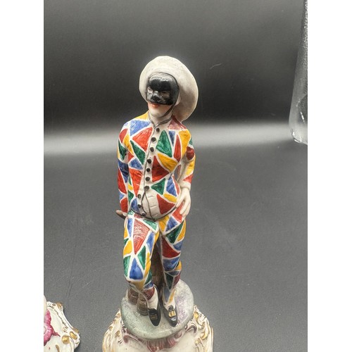 90 - A pair of antique chelsea pottery figures to include masked harlequin & masked figure with black coa... 