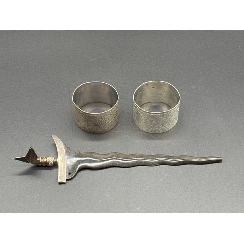 83 - Pair of London silver napkin rings along with Silver hand and horn blade Kris letter opener.