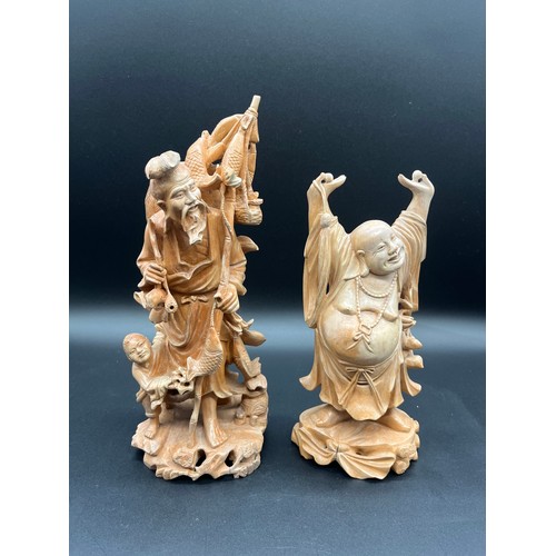 97 - 2 Japanese carved wood okimonos to include fisherman holding his catch and buddha tallest 10