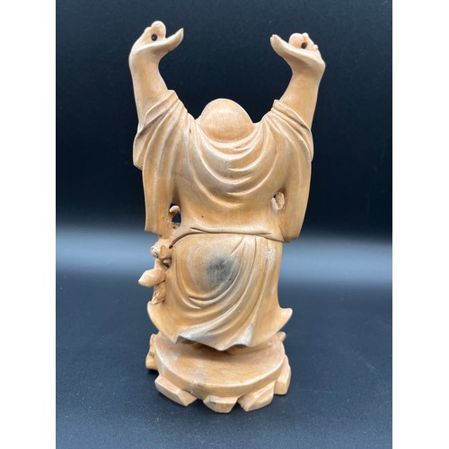 97 - 2 Japanese carved wood okimonos to include fisherman holding his catch and buddha tallest 10