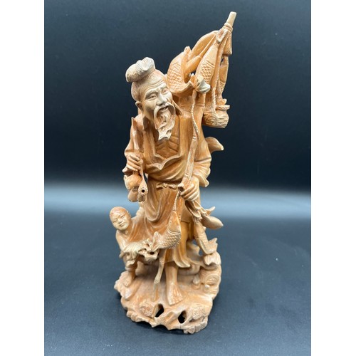 97 - 2 Japanese carved wood okimonos to include fisherman holding his catch and buddha tallest 10