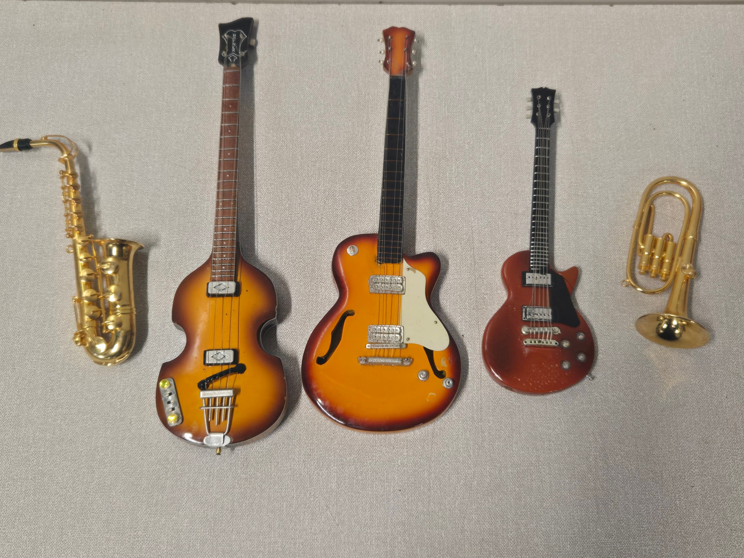 Selection of miniature instruments to include guitar lighter.