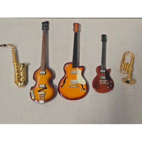 Selection of miniature instruments to include guitar lighter.