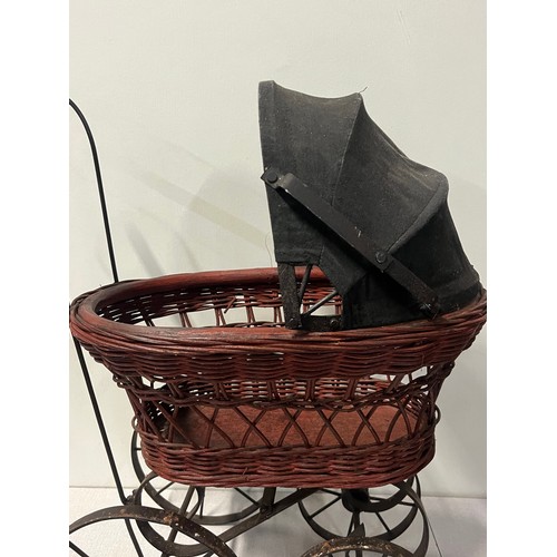 258 - Vintage Victorian style wicker and metal doll pram along with German Sunkid teddy bear.