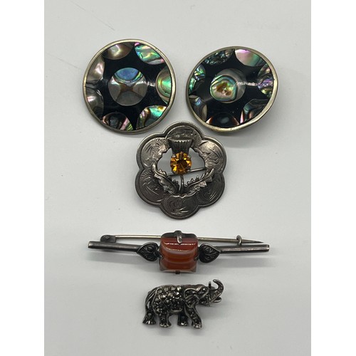 88 - Silver and carnelian brooch, silver and marcasite elephant brooch, silver plated Scottish brooch and... 
