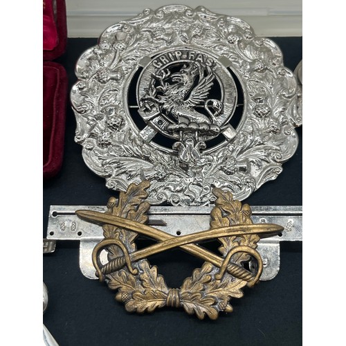 62 - Collection of military related items along with large clan and Celtic badges pins etc.