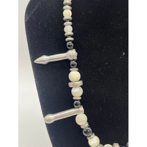 67 - Unusual tribal style necklace with onyx beads and silver toned spacers along with silver and pearl n... 