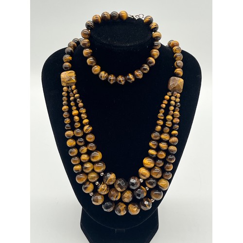 75 - Tigers eye necklace & bracelet both with silver fastenings.