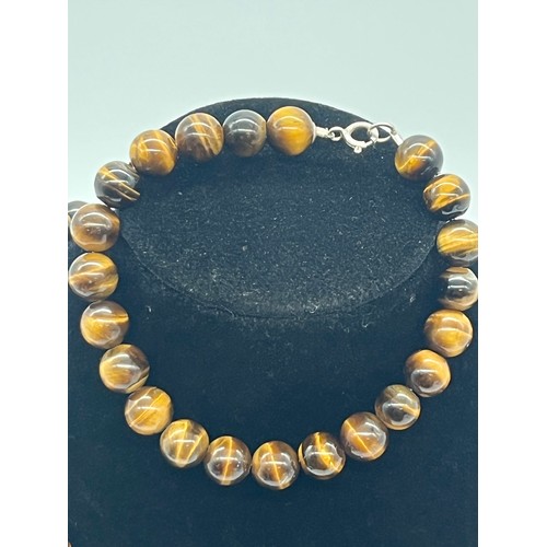 75 - Tigers eye necklace & bracelet both with silver fastenings.
