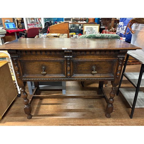 156 - Solid oak Jacobean style 2 drawer console table with heavy pull brass handles.