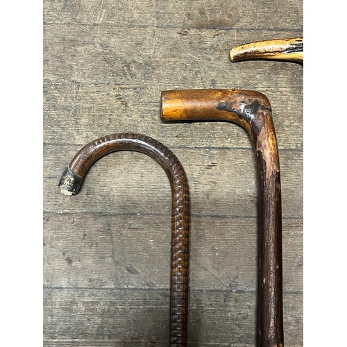 130C - 3 antique walking sticks/canes and one umbrella.