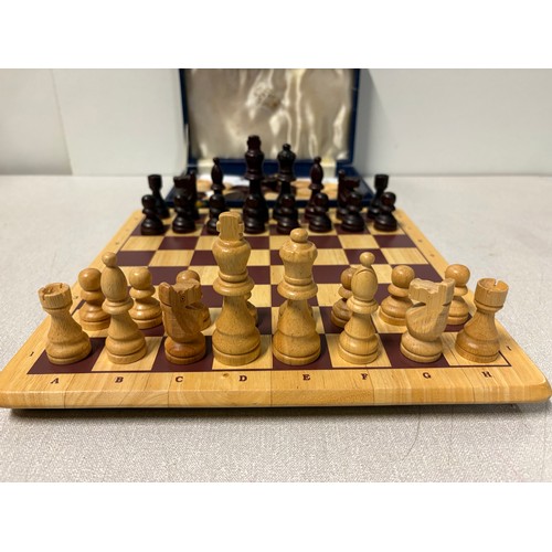A carved wooden chess & draughts set