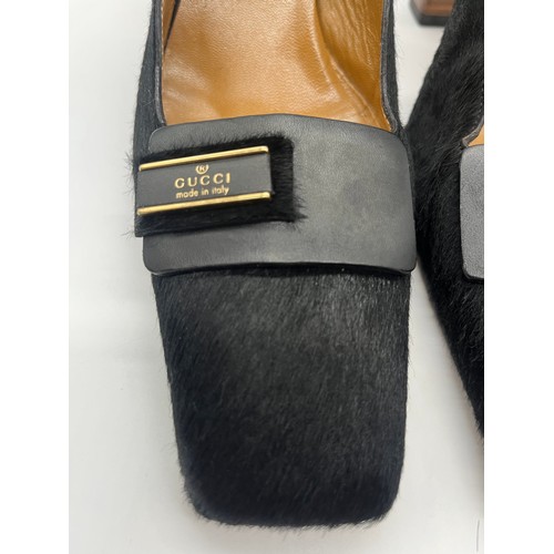 32 - Vintage Gucci pony hair slingback block heels featuring a black calfskin logo. Size 5.5