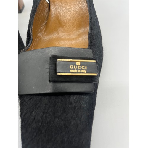 32 - Vintage Gucci pony hair slingback block heels featuring a black calfskin logo. Size 5.5