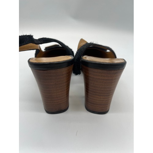32 - Vintage Gucci pony hair slingback block heels featuring a black calfskin logo. Size 5.5