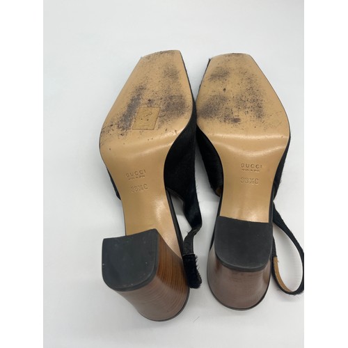 32 - Vintage Gucci pony hair slingback block heels featuring a black calfskin logo. Size 5.5
