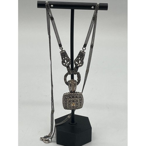 10 - Sterling silver and black diamond necklace with 14k gold accents.