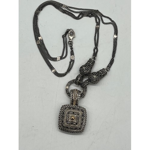 10 - Sterling silver and black diamond necklace with 14k gold accents.