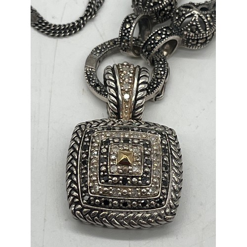 10 - Sterling silver and black diamond necklace with 14k gold accents.