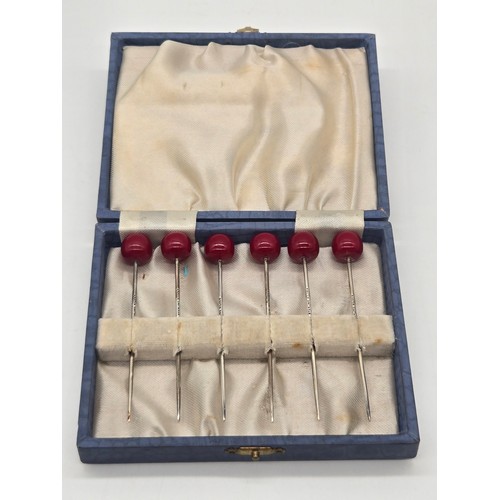16 - Set of 6 Art Deco sterling silver cherry topped cocktail sticks in fitted case.
