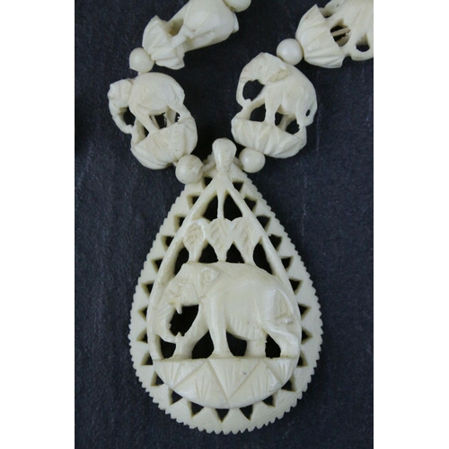 309 - Carved Bone Elephant Necklace together with Carved Bone and Stone Charms including Buddha