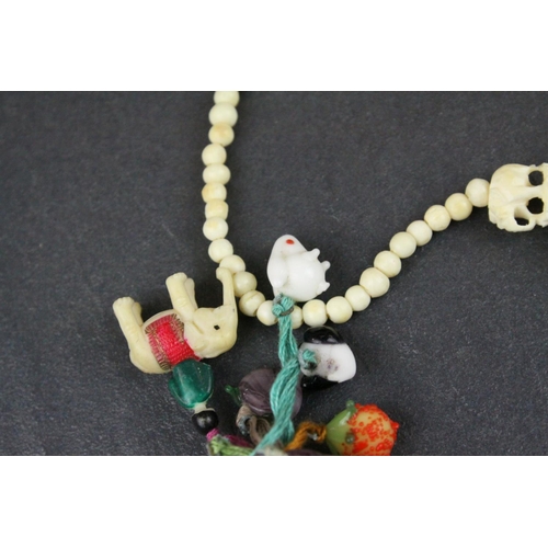 309 - Carved Bone Elephant Necklace together with Carved Bone and Stone Charms including Buddha