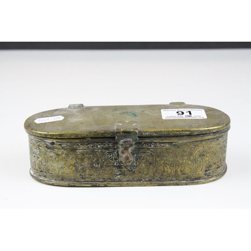 91 - Persian Brass Oval Box, the lid opening to reveal a interior panel covering a fitted interior, possi... 