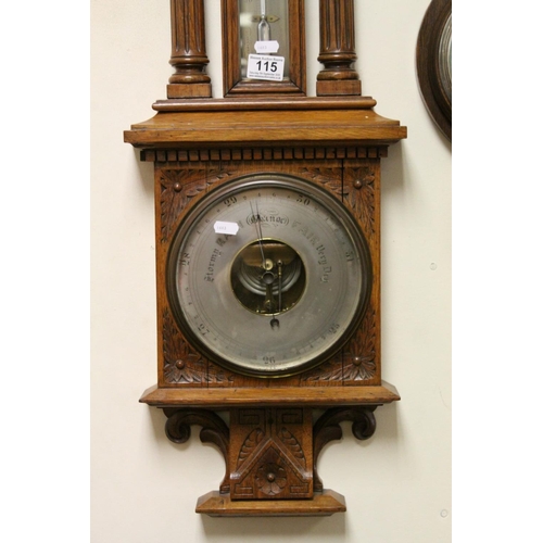 115 - Antique oak carved Aneroid barometer and thermometer  with reeded below a proscenium arch.