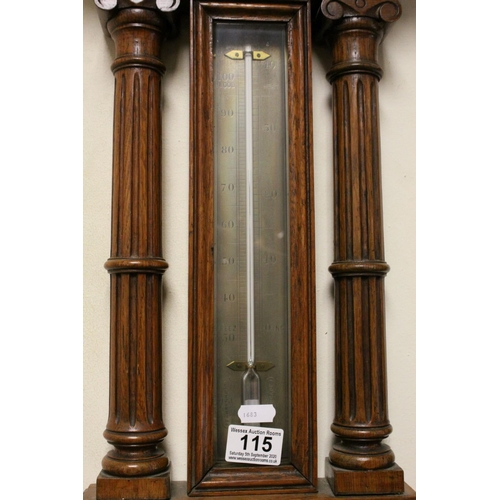 115 - Antique oak carved Aneroid barometer and thermometer  with reeded below a proscenium arch.