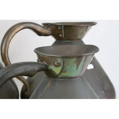 75 - Set of Four Late 19th / Early 20th century Copper Graduating Measuring Jugs, ranging from 4 gallons ... 
