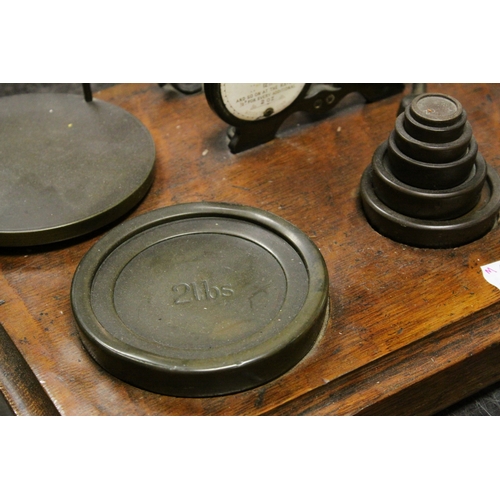 103 - Victorian Oak Postal Scales by Houghton & Sons, London with Weights, 42cms wide