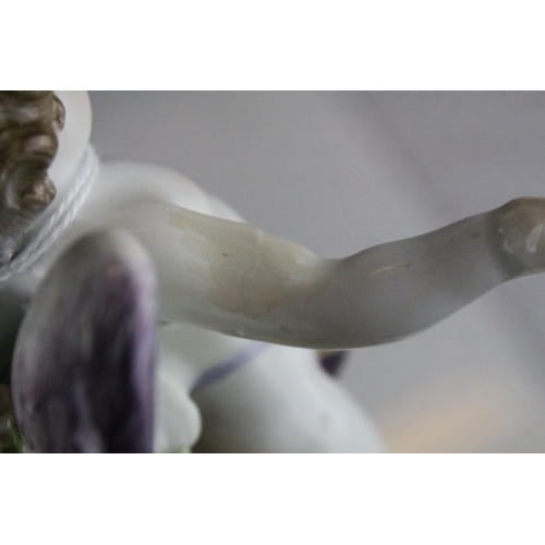 20 - Meissen Porcelain Figure of Cupid with open arms, the base decorated with gilt scrolls, blue cross s... 