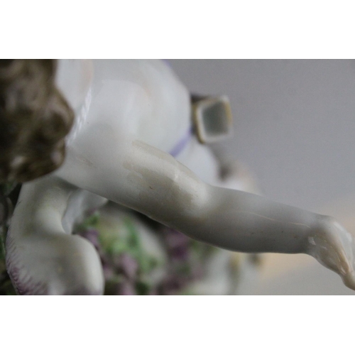 20 - Meissen Porcelain Figure of Cupid with open arms, the base decorated with gilt scrolls, blue cross s... 