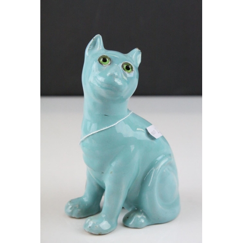 28 - In the manner of Galle, A Mosanic Pottery Seated Cat, glazed in yellow with blue painted hearts and ... 