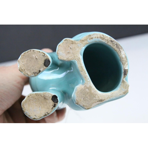 28 - In the manner of Galle, A Mosanic Pottery Seated Cat, glazed in yellow with blue painted hearts and ... 